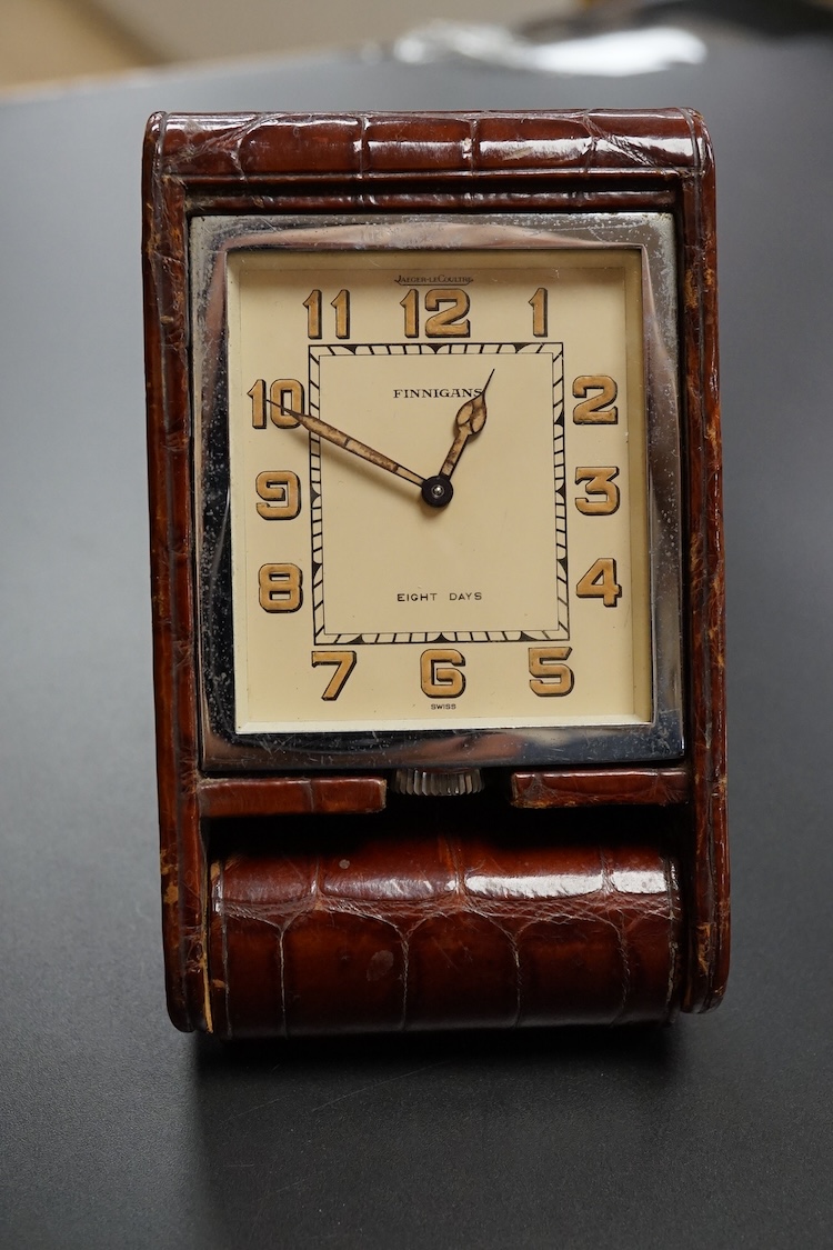 A Finnegan's leather cased travelling timepiece and a base metal Glow Worm pocket watch.